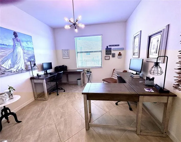 Office area with baseboards and suspended lighting