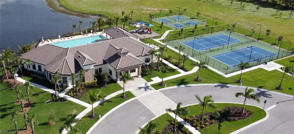 Drone / aerial view of a nearby body of water and a pool