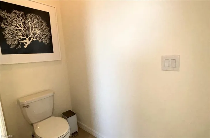 Bathroom featuring toilet and baseboards