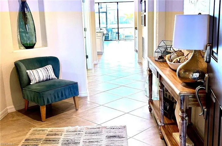 Corridor with light tile patterned floors and baseboards
