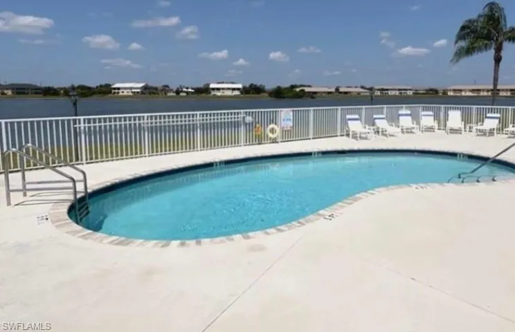 Community pool featuring a patio and a water view