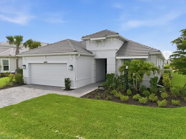 Contemporary single-story residence with a tiled roof and stucco exterior