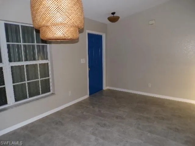 Unfurnished room with baseboards