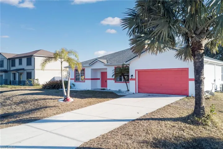 Ranch-style house featuring stucco siding, concrete driveway, and an attached garage
