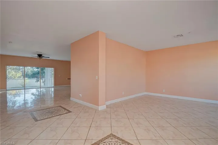 Spare room with light tile patterned floors and a ceiling fan