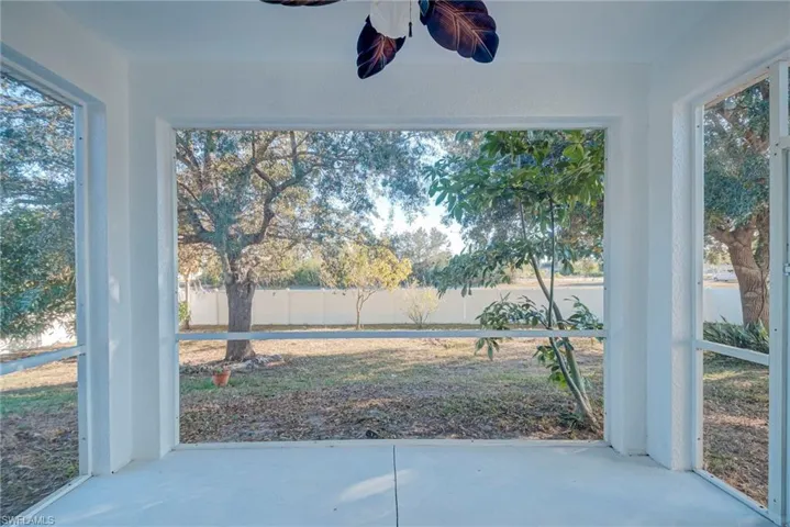 Unfurnished sunroom with concrete flooring