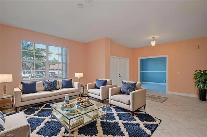 Living area with baseboards and light tile patterned floors