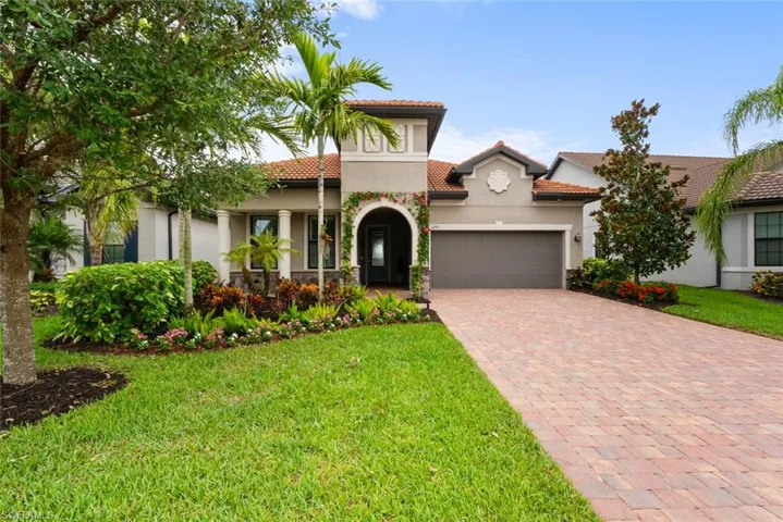 Mediterranean / spanish house featuring a front yard and a garage