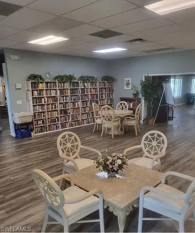 Dining area with a drop ceiling and hardwood / wood-style flooring