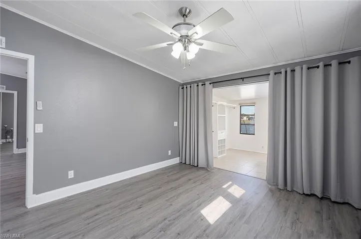 Spare room with ceiling fan and light wood-type flooring