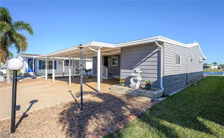 Rear view of property featuring a lawn