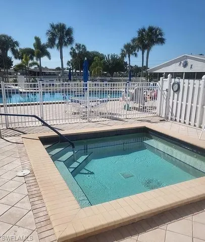 View of pool featuring a water view and a patio