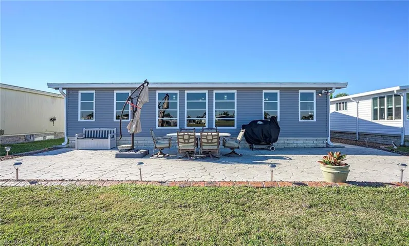 Back of property featuring a patio area and a yard