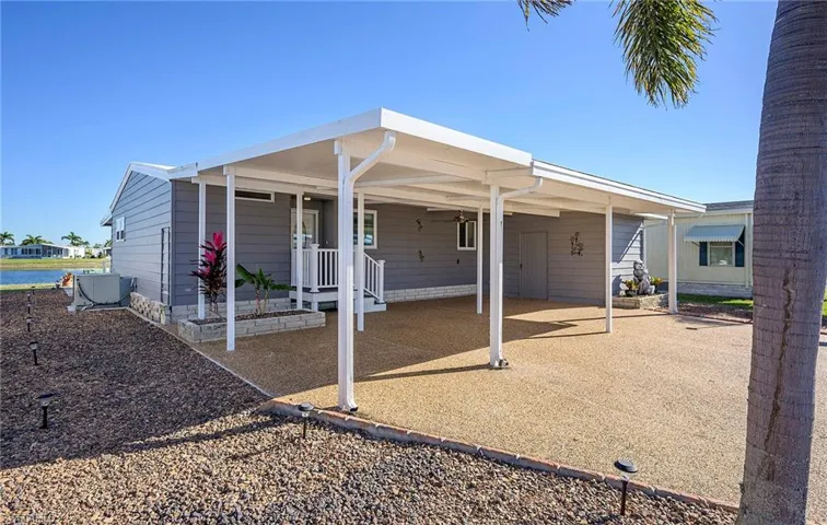 Rear view of property with a carport