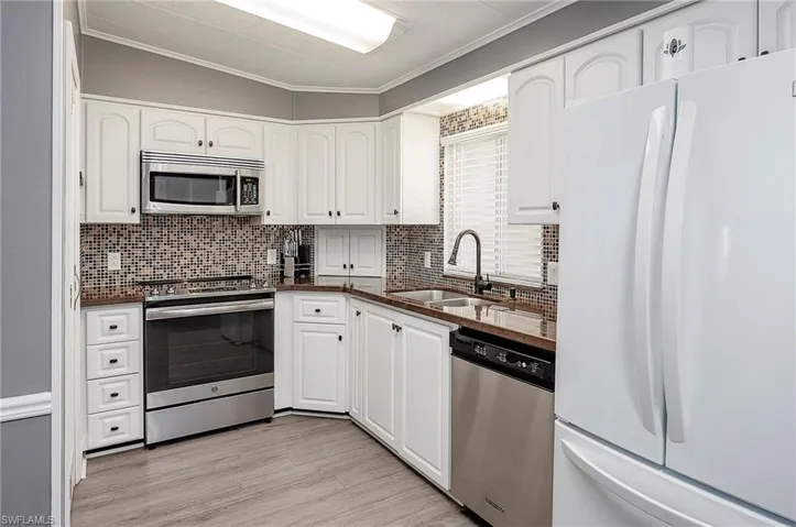 Kitchen with white cabinets, sink, and stainless steel appliances