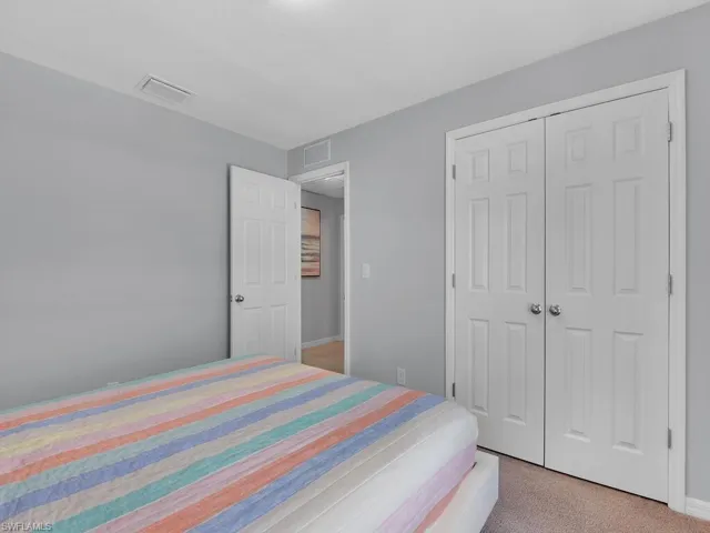 Bedroom featuring a closet and light colored carpet
