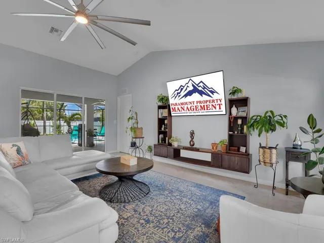 Living room with ceiling fan and vaulted ceiling