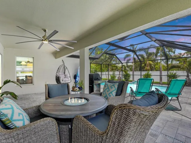 View of patio / terrace with a lanai, a grill, and ceiling fan