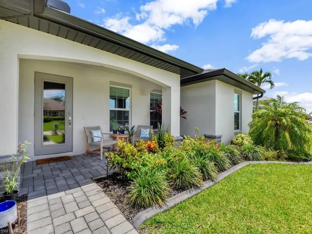 Doorway to property featuring a yard