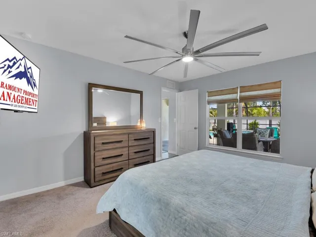 Carpeted bedroom with ceiling fan