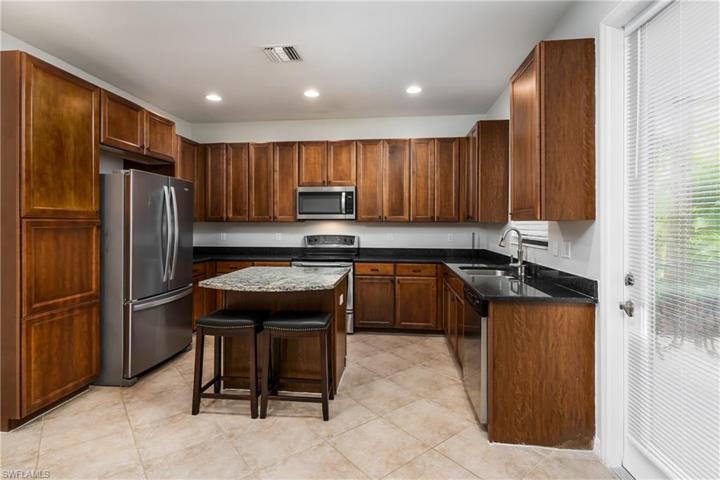 So many cabinets to chef's delight. Door leading out to screened-in lanai