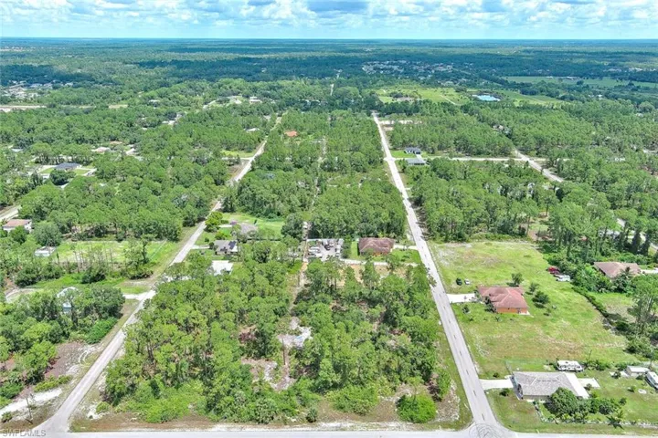 Aerial view of property's location with a heavily wooded area