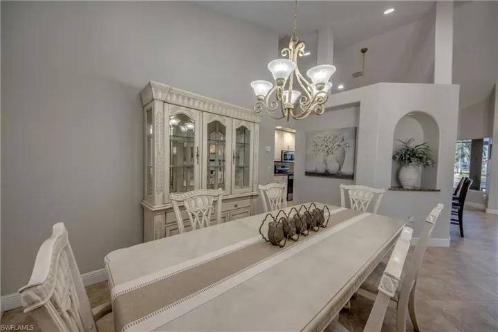 Dining area featuring a high ceiling and hanging lights