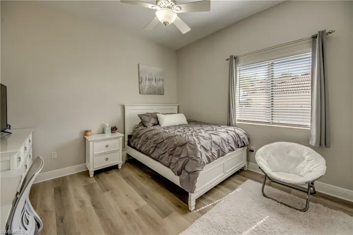 Bedroom with light wood finished floors and ceiling fan