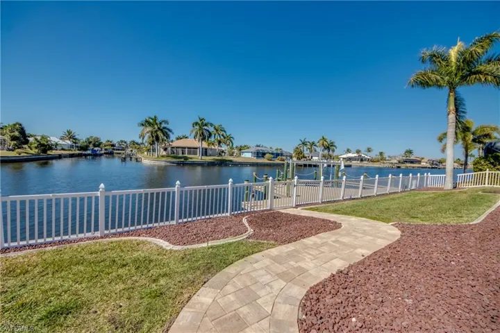 View of yard with a boat dock, a water view, and a residential view