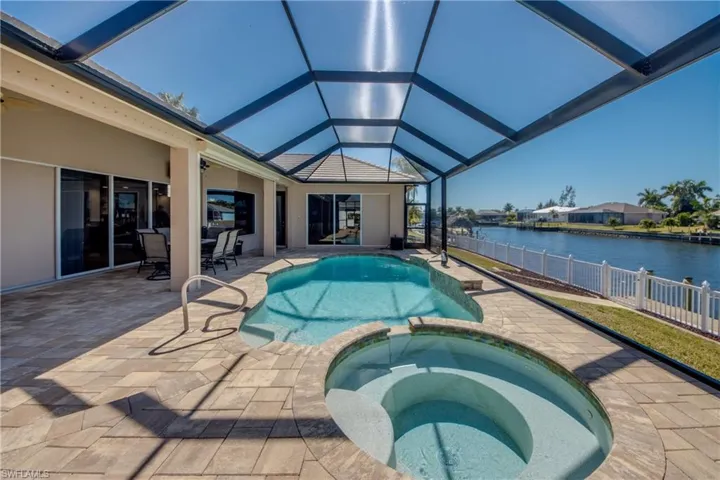 Integrated pool / spa featuring a patio area, a lanai, a sunroom, and outdoor dining space