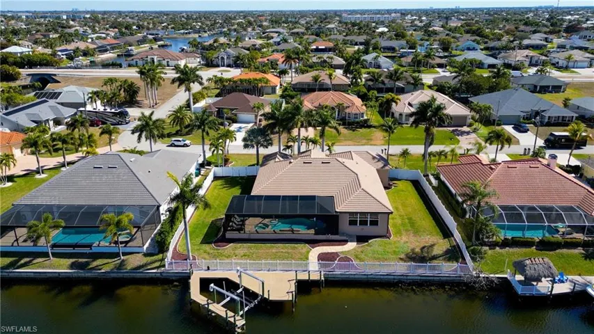 Aerial perspective of suburban area featuring a nearby body of water
