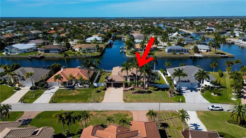 Aerial view of property and surrounding area with nearby suburban area and a nearby body of water