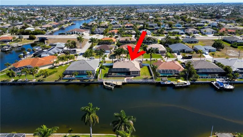 Aerial overview of property's location featuring a large body of water and nearby suburban area