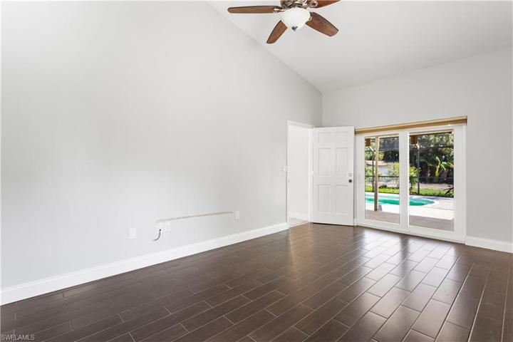 Primary Bedroom with sliders to back lanai and pool
