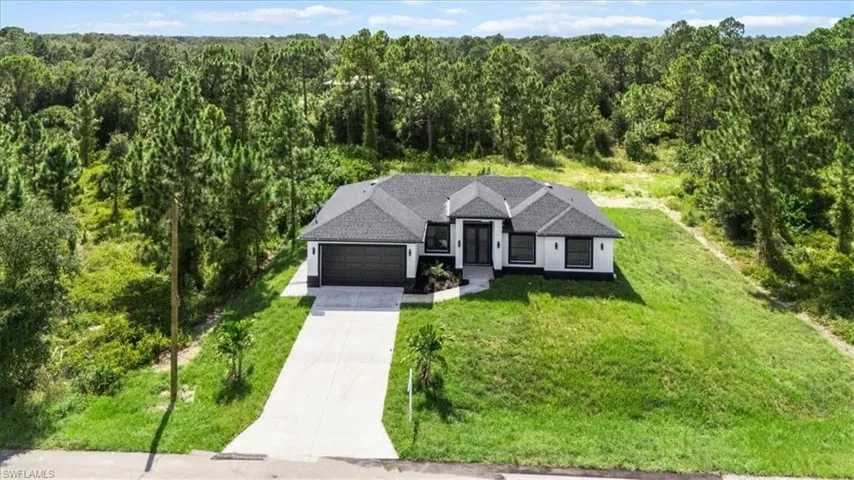 View of subject property with a heavily wooded area