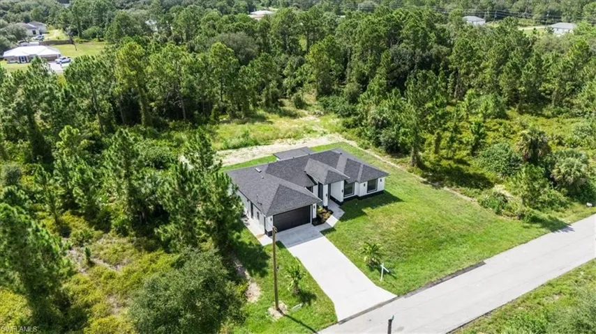 View from above of property featuring a heavily wooded area
