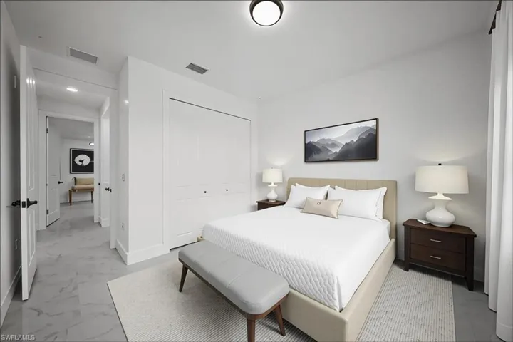Bedroom with a closet and light marble finish flooring