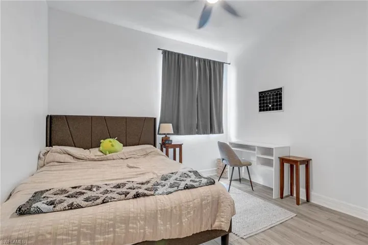 Bedroom with hardwood / wood-style flooring and ceiling fan