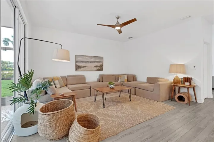 Living room featuring light hardwood / wood-style floors and ceiling fan