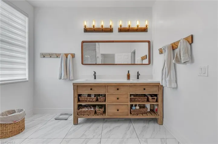 Bathroom with tile flooring, double sink, and large vanity
