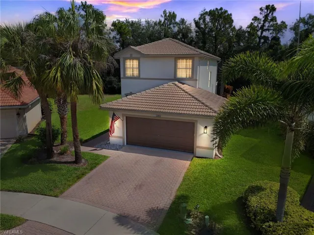 Mediterranean / spanish-style house with a garage and a yard