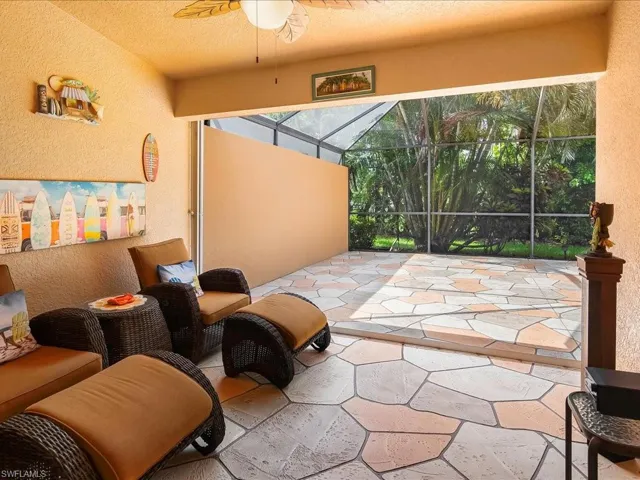 View of patio / terrace featuring a ceiling fan and glass enclosure