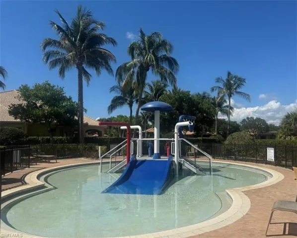 Community pool featuring a water play area