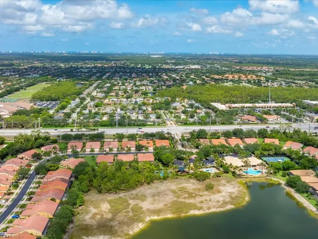 Aerial overview of property's location featuring nearby suburban area and a nearby body of water