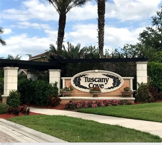 Community / neighborhood sign featuring a lawn