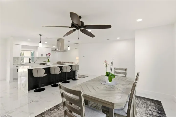 Dining area featuring recessed lighting, light marble finish floors, and ceiling fan