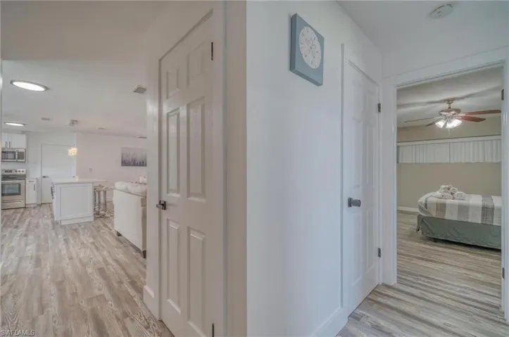 Corridor featuring light wood finished floors