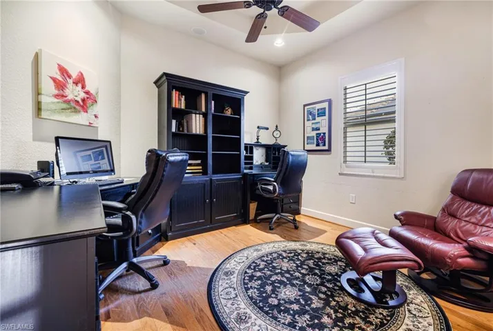 Office space with  tray ceiling with fan, Plantation Shutters and Real Hardwood floors