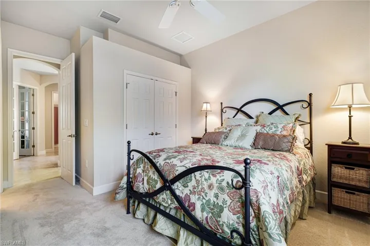 Guest Bedroom has ensuite bathroom, Plantation Shutters and closet with custom built-in shelving