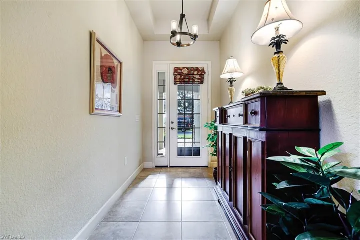 Entry way with tray ceiling and screened door to take advantage of our Florida Breezes